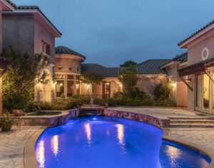 Texas CEO Ranch, a large spanish style house with a large pool.